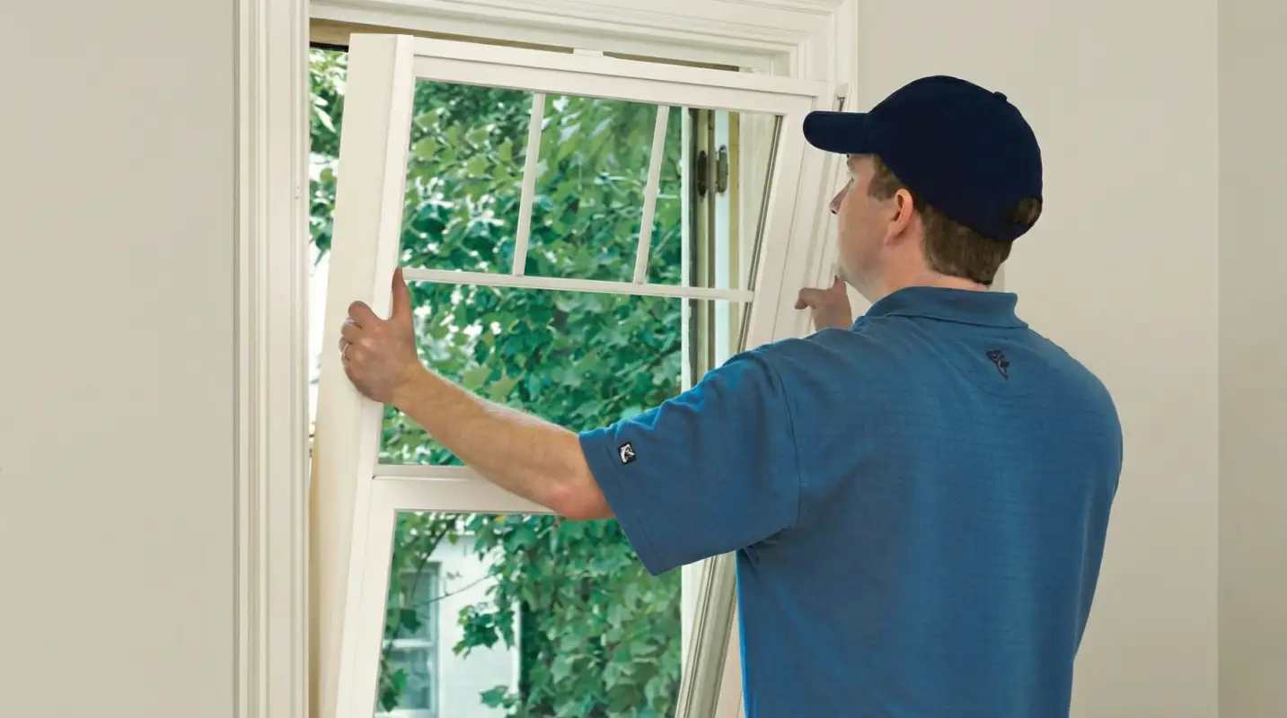 Professional contractors performing a residential window insulation and replacement service in Buffalo, NY